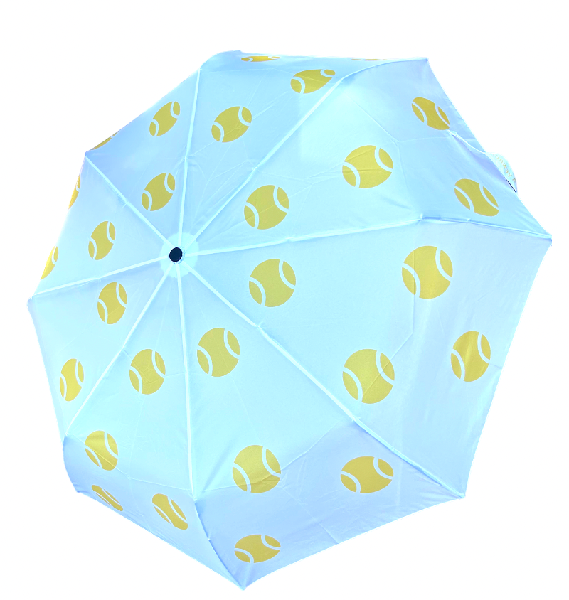 The Runway Athletics Umbrella - Yellow Tennis Balls is displayed open from above, showcasing its light blue 8-panel canopy with a repeating yellow tennis ball pattern against a plain white background.