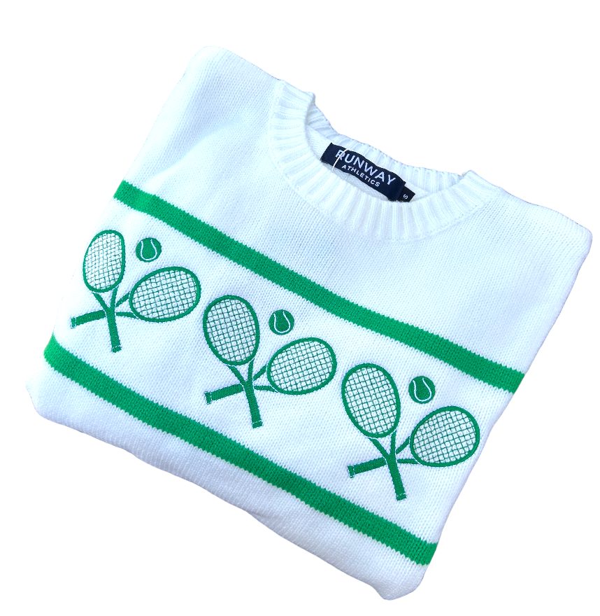 The Tennis Racquets Sweater in cream and green by Runway Athletics features a crew neck, two horizontal green stripes, and four crossed rackets with three tennis balls on the front. The Runway Athletics label appears at the collar.