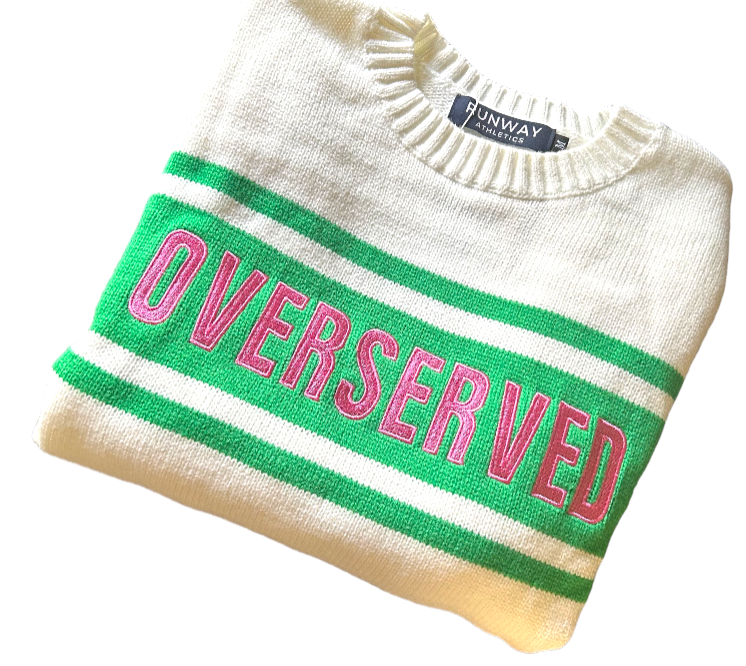 The Overserved Sweater by Runway Athletics is a white crew neck tennis sweater with green stripes and bold pink "OVERSERVED" lettering on the front, plus a visible Runway Athletics label at the collar against a plain white background.