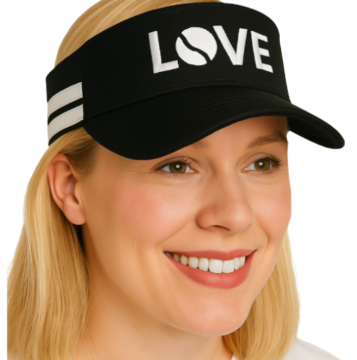 A smiling woman in a white top wears the Runway Athletics Striped Cotton Canvas LOVE Visor in black with "LOVE" (O as a tennis ball) and two white stripes, providing sun protection. She stands against a plain background.