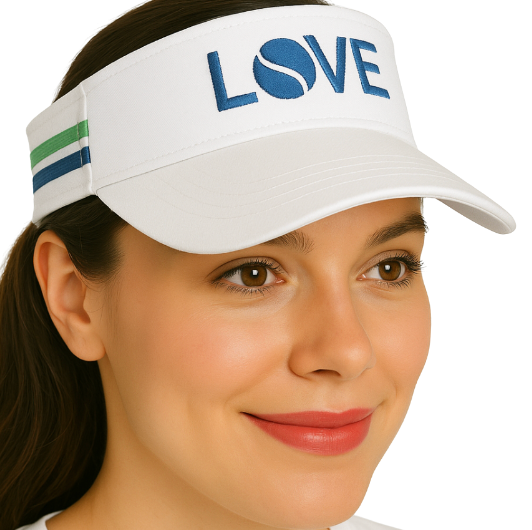 A woman smiles, wearing the Striped Cotton Canvas LOVE Visor by Runway Athletics—white with navy “LOVE” and a tennis ball for the “O,” plus green and blue side stripes for sun protection. She has straight brown hair and natural makeup.