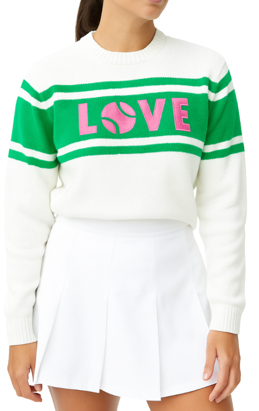 A woman wears the Runway Athletics LOVE Sweater in pink, green & cream—featuring “LOVE” with a tennis ball "O"—paired with a white pleated skirt. Her dark hair is pulled back, and her face is partially out of frame.