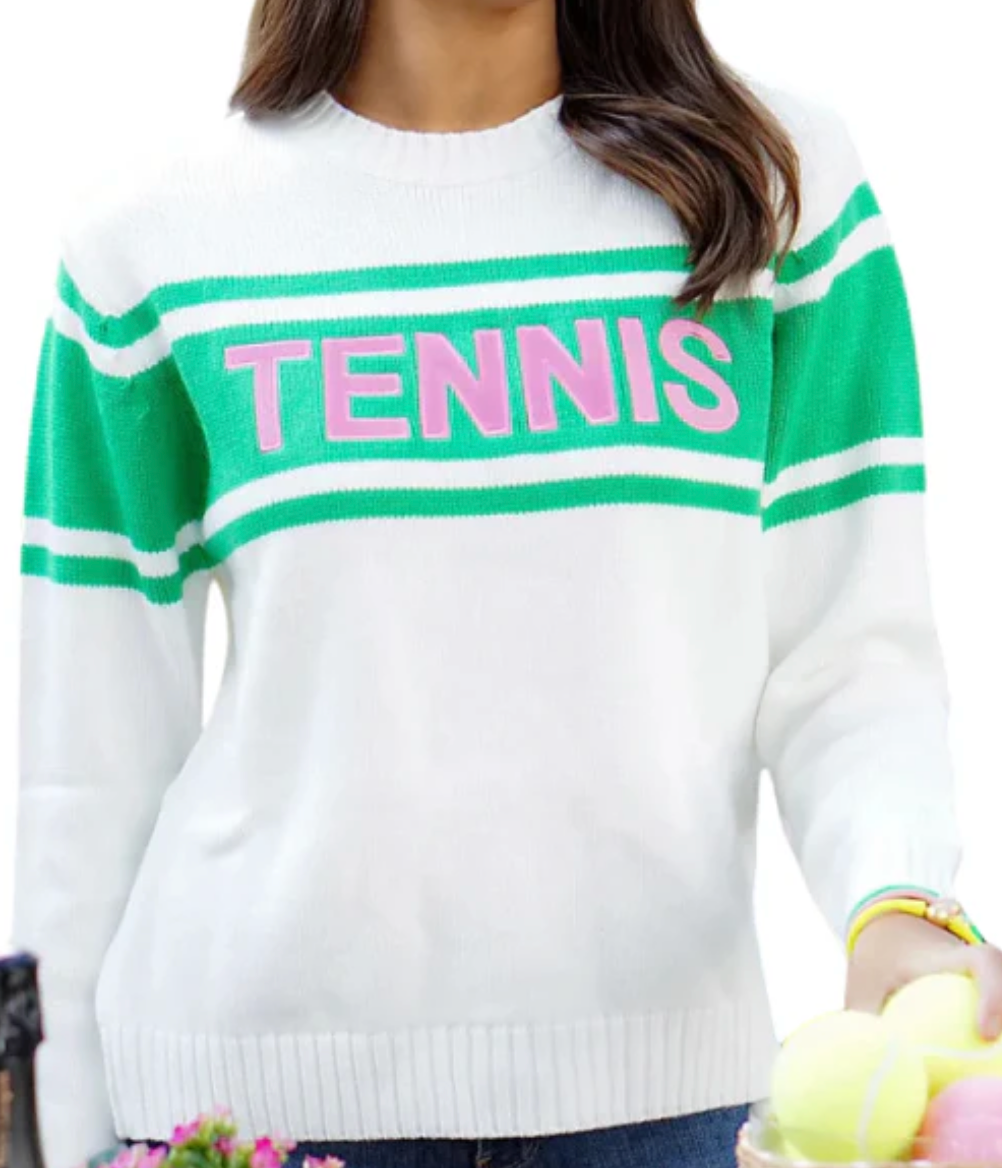 A woman holds tennis balls while wearing the Runway Athletics "Green with 'Tennis' Envy" embroidered hat from the gift set.