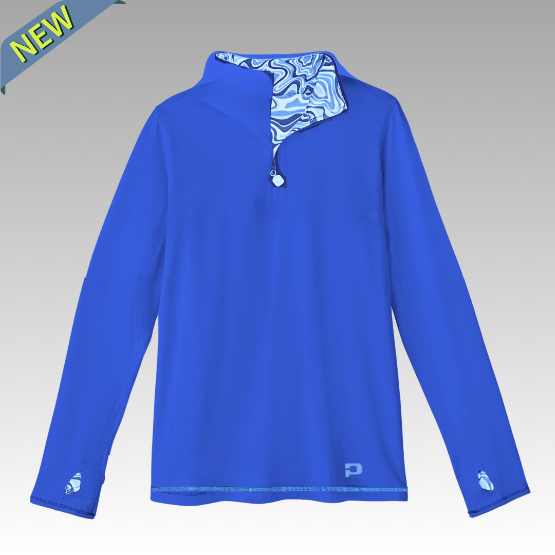 The Playly Store Soleil Tech Shirt is a royal blue long sleeve pullover with a quarter-zip collar, blue and white geometric inner collar, breathable UV-protective fabric, and a small “P” logo. Gray gradient backdrop with a “NEW” banner.