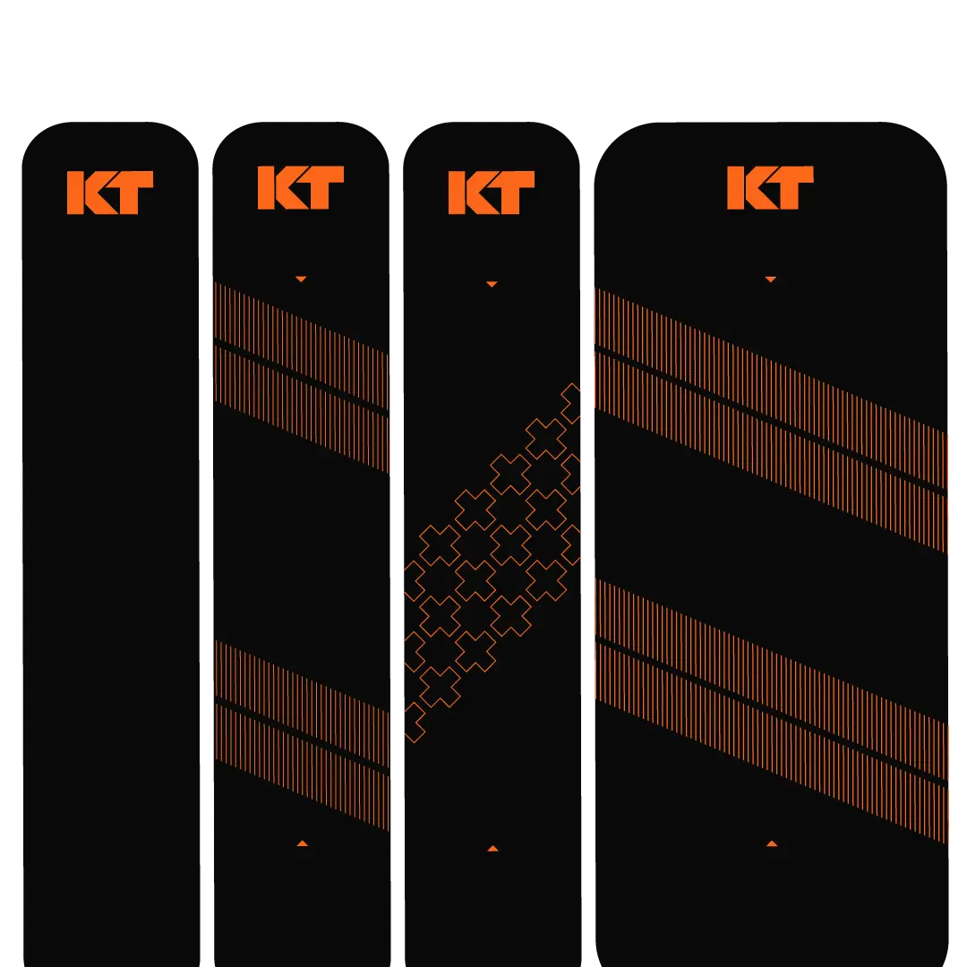 The KT Tape Starter Pack by KT Tape features four black skis with orange KT logos: two with three diagonal orange lines, one with puzzle piece graphics, and one showing two thick crossing orange diagonal lines reminiscent of kinesiology tape.