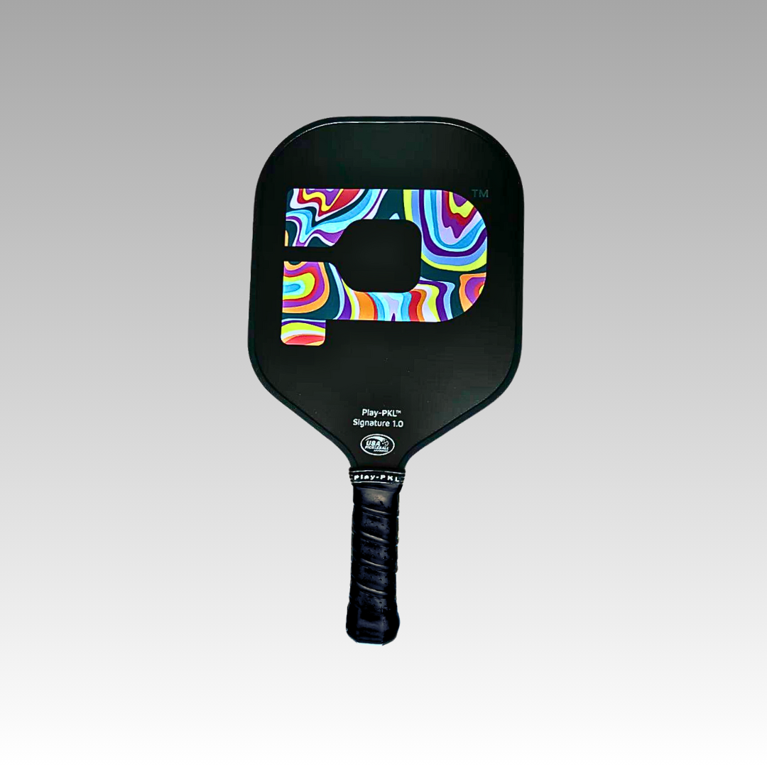 The Signature Pickleball Paddle from Playly Store features a black graphite surface with a colorful swirl pattern inside a bold P, black grip tape on the handle, and "Play PKL Signature 1.0" in white near the top against a light gray background.