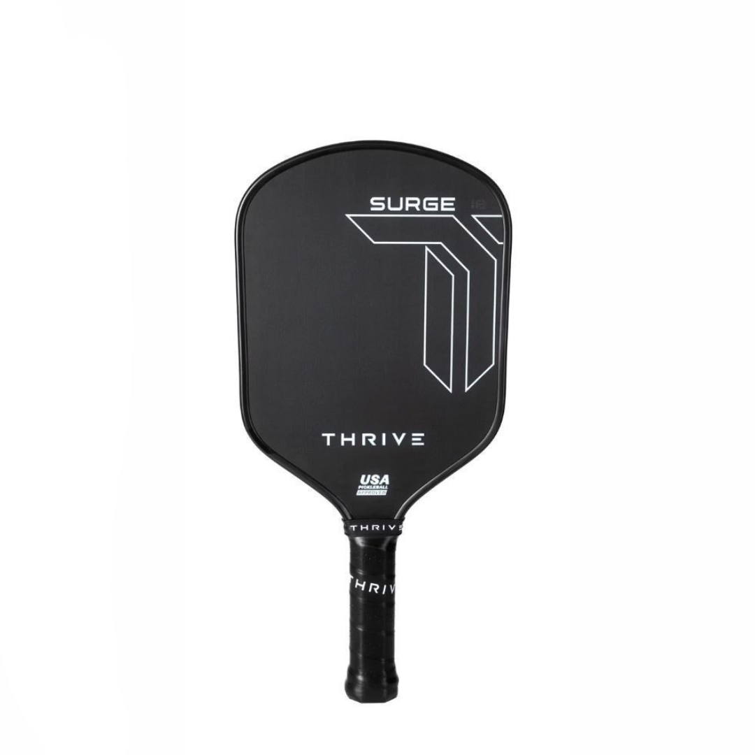 The Thrive Pickleball Surge 16 MM (ALL COURT SERIES) paddle features a black carbon fiber face with “SURGE” and white geometric lines, “THRIVE,” and the USA PICKLEBALL APPROVED logo. Includes lead weights, paddle eraser, key chain, and weight card.