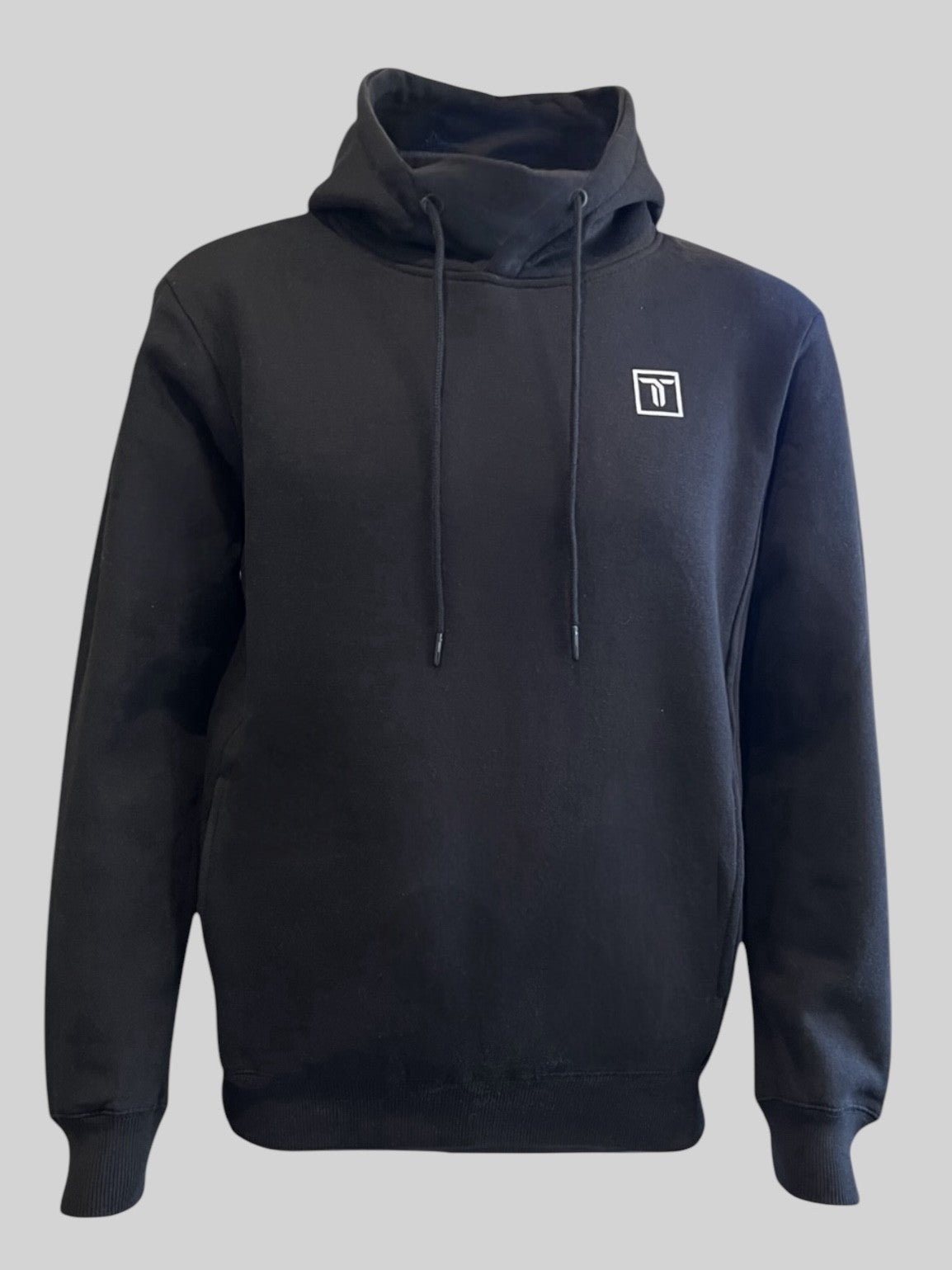The Thrive Elite Hoodie by Thrive Pickleball is a black recycled polyester, regular fit hoodie with a high neck, two drawstrings, and a small white rectangular logo on the left chest, shown against a plain gray background.