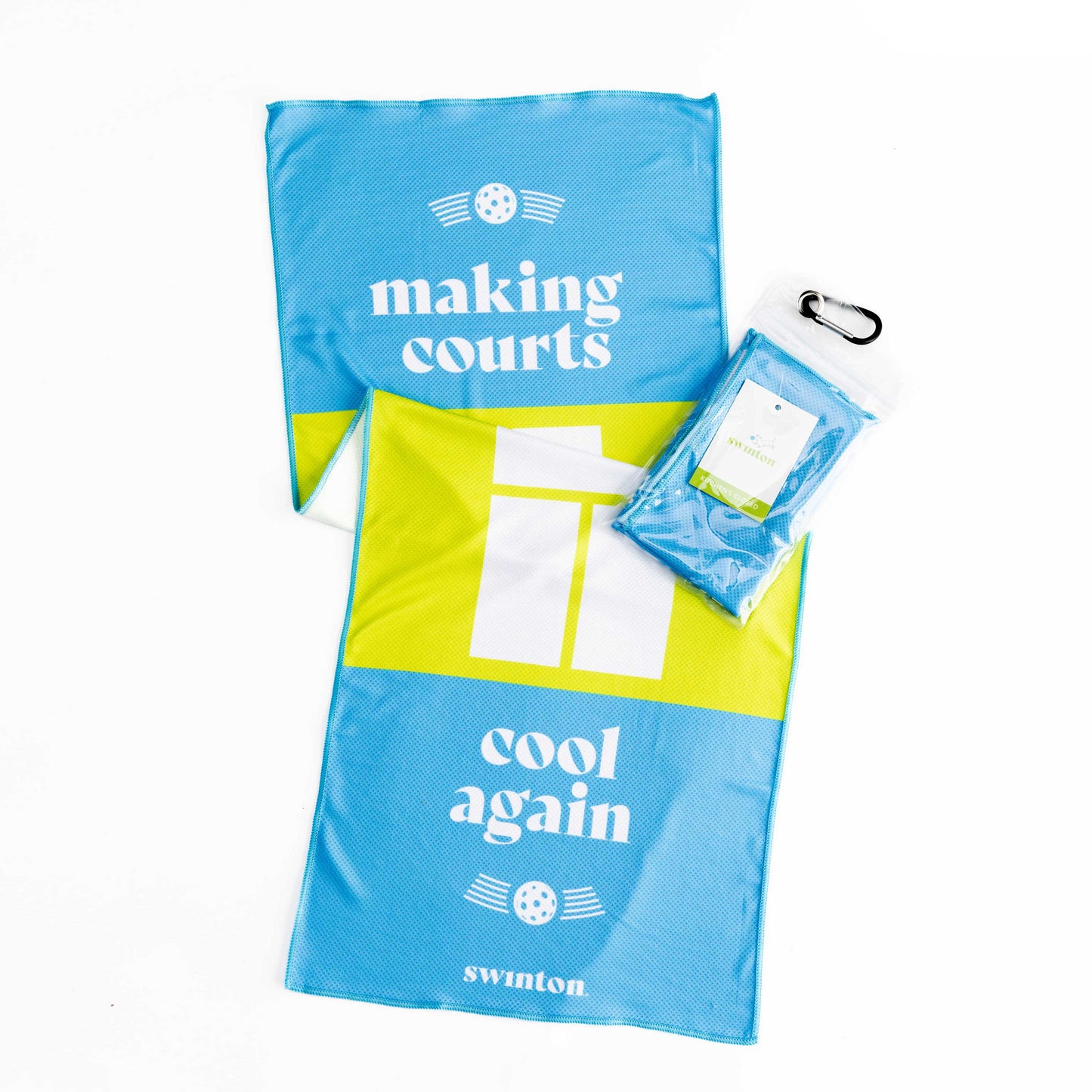 Two Swinton Pickleball Court Cooling Towels—blue and yellow with "making courts" and "cool again" in white, plus paddle and ball graphics. A third towel is folded in clear plastic with a black carabiner. Great gift for pickleball fans!.