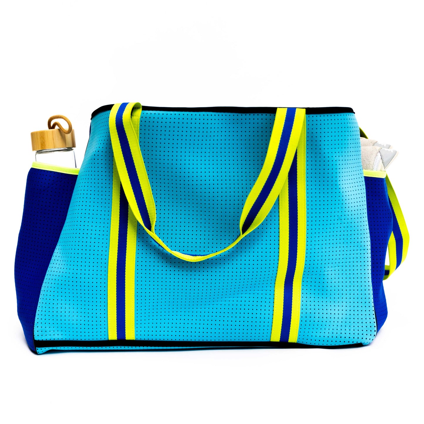 The Swinton Pickleball XL Pickleball Tote Bag in blue features yellow and navy stripes, yellow handles, side pockets for a water bottle with a wooden lid on the left and a clear pouch on the right, all set against a white background.