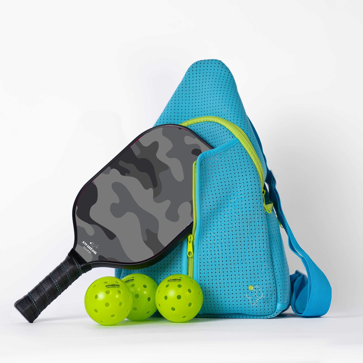 The Swinton Pickleball Starter Bundle - Blue includes a blue perforated sports bag, a black-and-grey camo paddle, and three bright yellow pickleballs—the perfect pickleball gift, set against a white background.