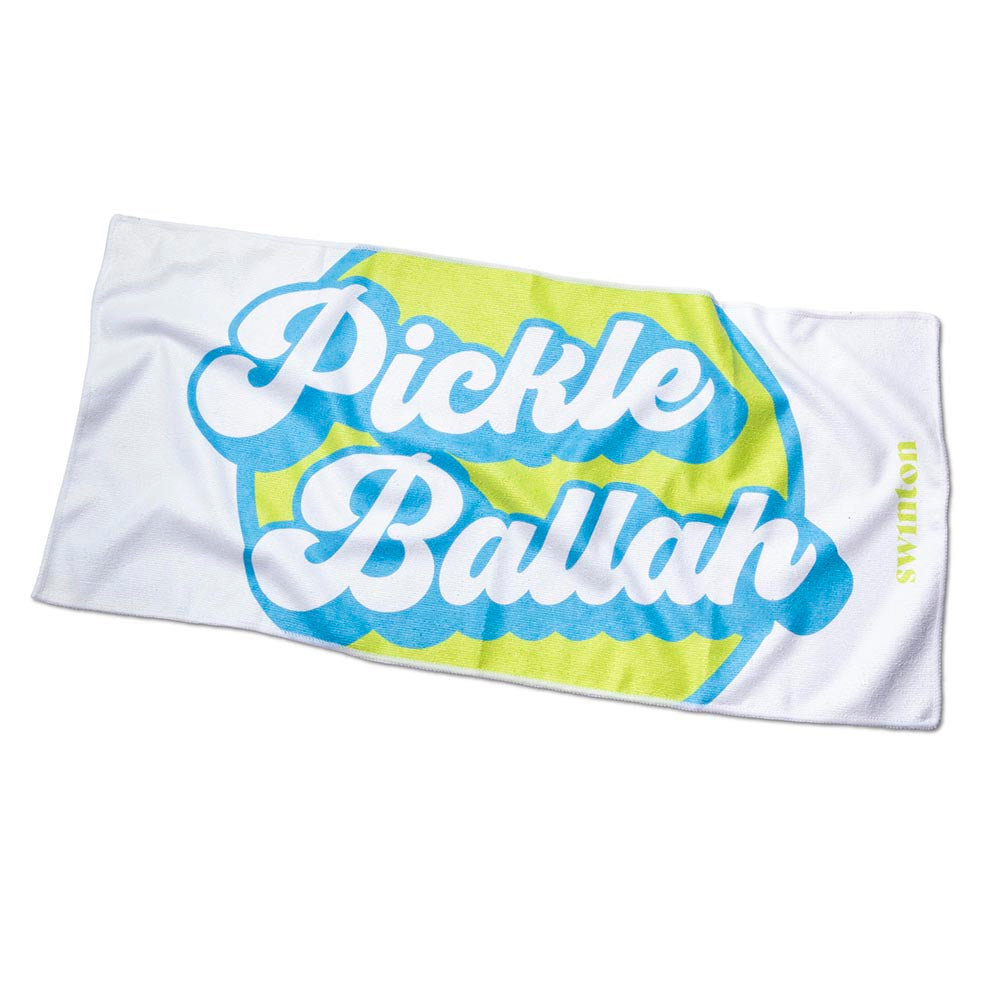The Swinton Pickleball Sports Towel White features “Pickle Ballah” in bold blue cursive over a yellow and blue pickleball graphic, with "UDVILLEUSA" in small yellow letters along the right edge. The towel is slightly wrinkled.