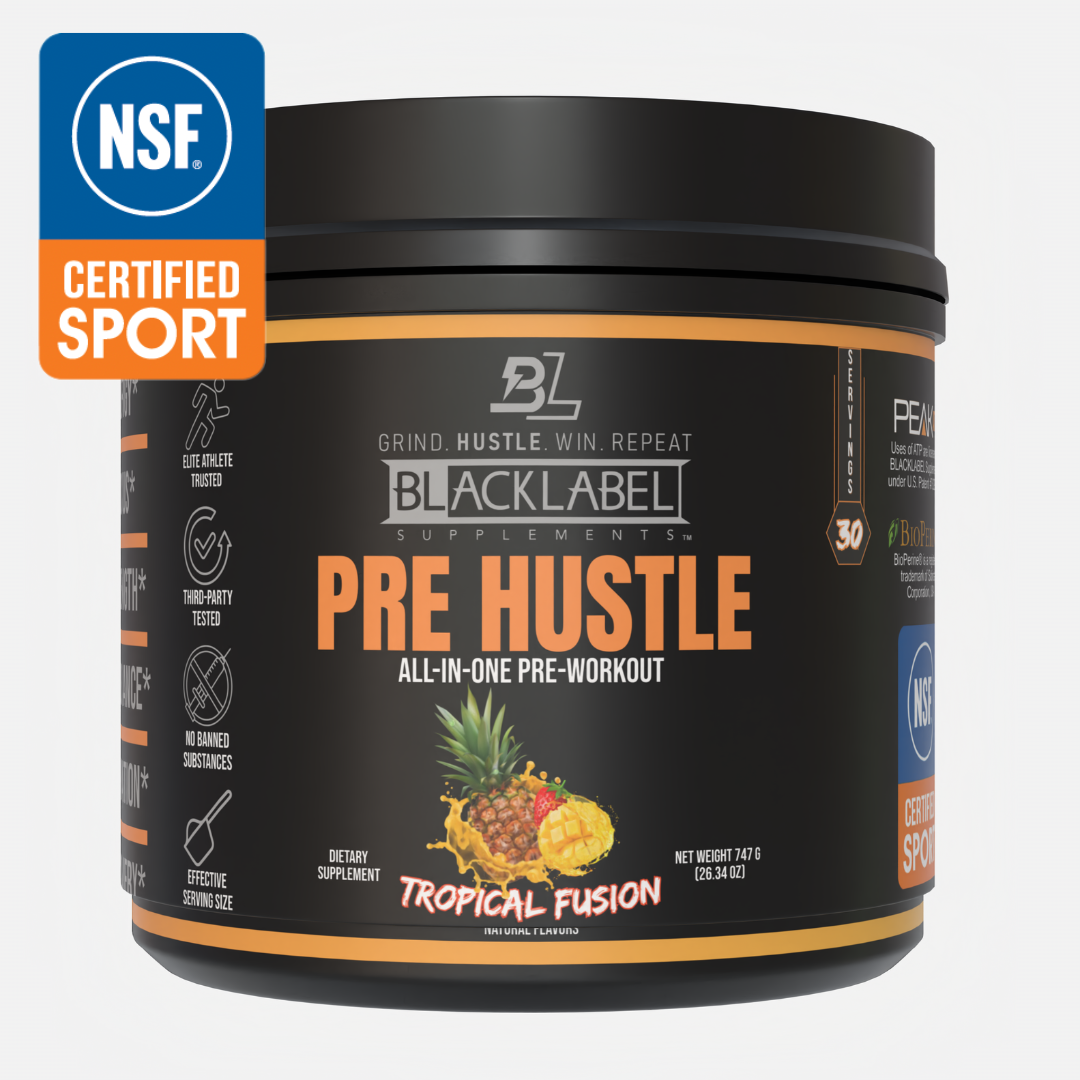 A black tub of BLACKLABEL Supplements PRE HUSTLE V3 pre-workout powder (Tropical Fusion) features muscle-building nutrients, with a label showing pineapple, mango, coconut, and an NSF Certified Sport badge at the top left corner.