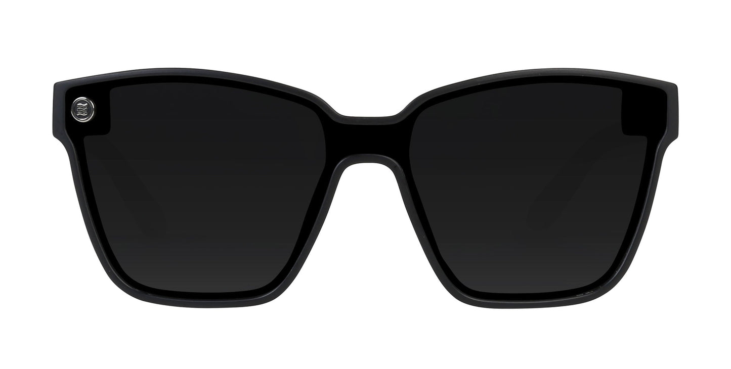The Neven Eyewear Atlantis sunglasses feature black rectangular frames, thick temples, dark polarized UV400 lenses, and a small silver circular logo on the upper left front, shown from the front against a white background.