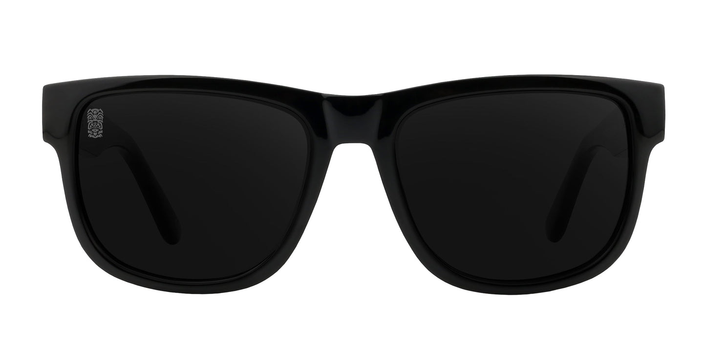 The Neven Eyewear Sade sunglasses feature thick, glossy rectangular frames and dark polarized lenses, shown front-facing on a white background. The arms are partially visible with a small silver detail near the left hinge.
