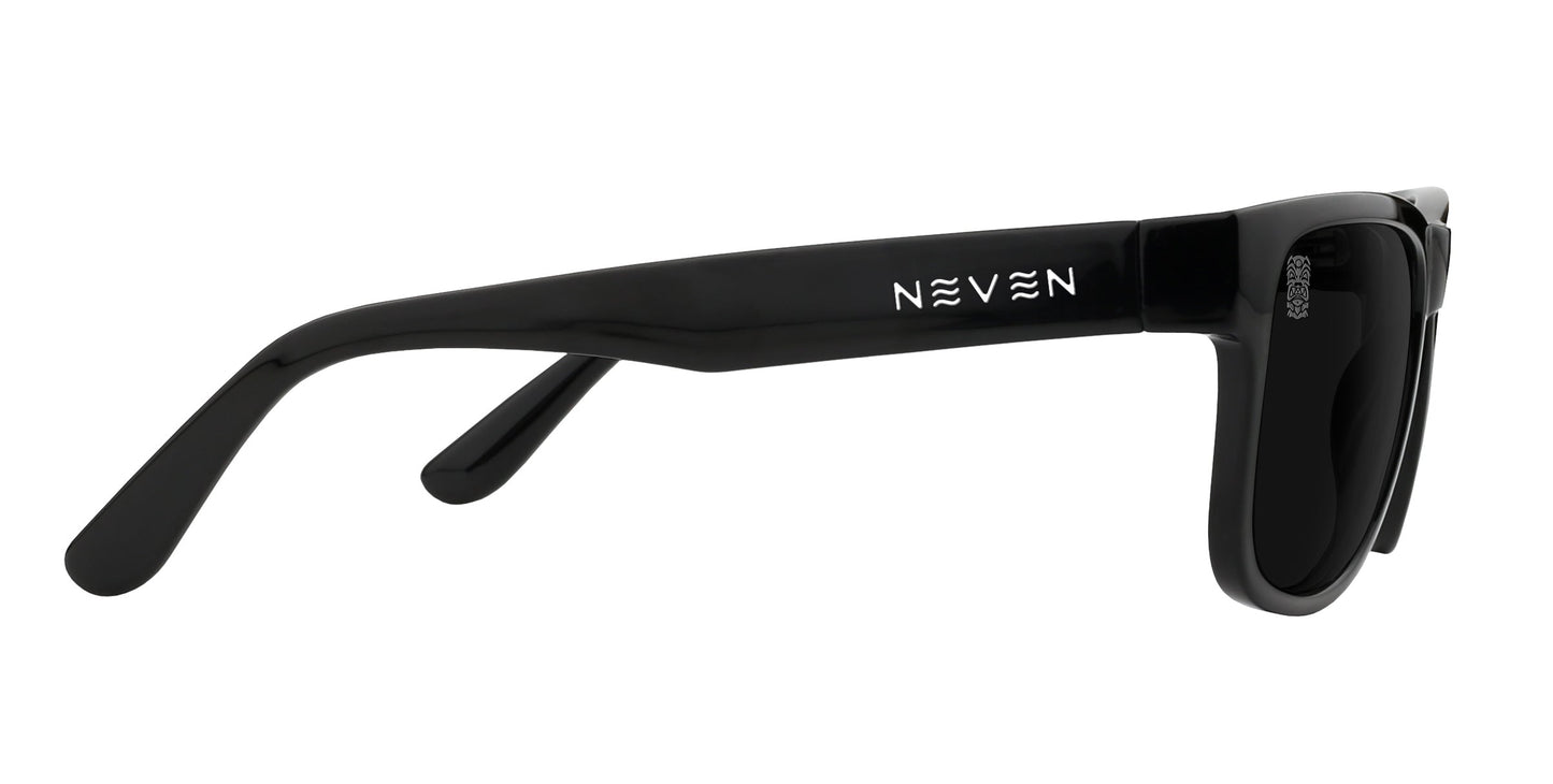 Side view of Neven Eyewear Sade sunglasses with thick black frames and dark polarized lenses. "NEVEN" in white with mirrored Es appears on the temple arm, and a glossy finish stands out against a plain white background.