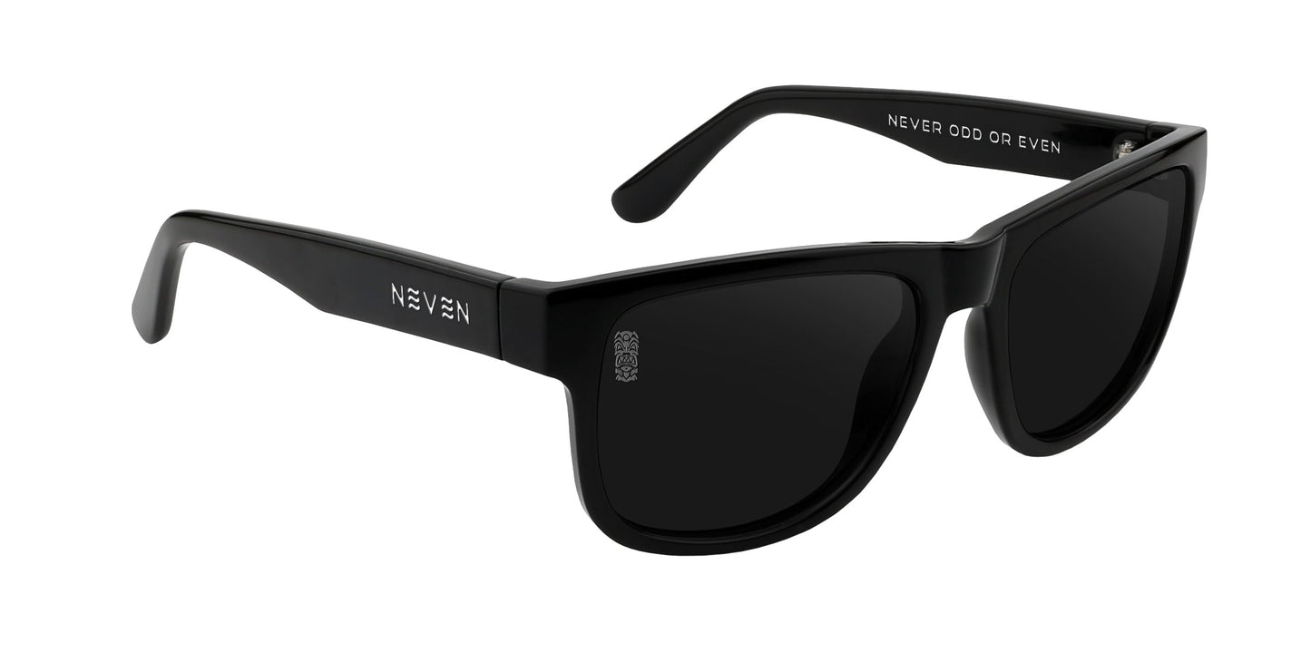 The Sade by Neven Eyewear are black, rectangular sunglasses with dark lenses. "NEVEN" is printed in white on the left arm, and "NEVER ODD OR EVEN" appears inside the right arm in white capital letters.