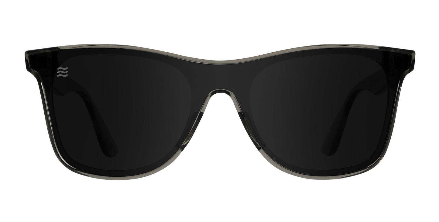 Front view of Neven Eyewear Elf sunglasses, black wayfarer-style frames with dark polarized lenses and UV400 protection. Part of the Thestral Collection; subtle logo on left lens. Background is white.