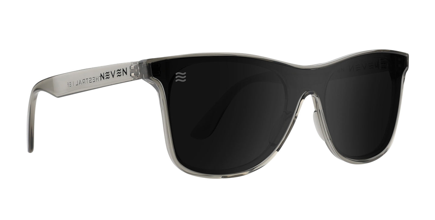 Elf polarized sunglasses from Neven Eyewear’s Thestral Collection feature thick transparent gray frames, wide solid black UV400 lenses, and a modern curved design. "NEVEN" and white text are displayed on the left arm.