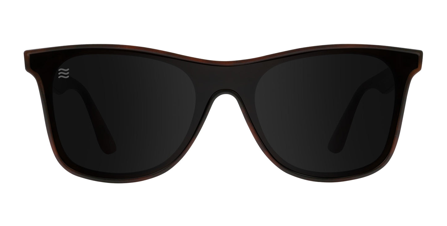 A pair of Neven Eyewear Warlock sunglasses with rectangular black frames and dark tinted lenses, shown from the front on a white background. Features polarized UV400 protection and a subtle logo on the top left lens corner.