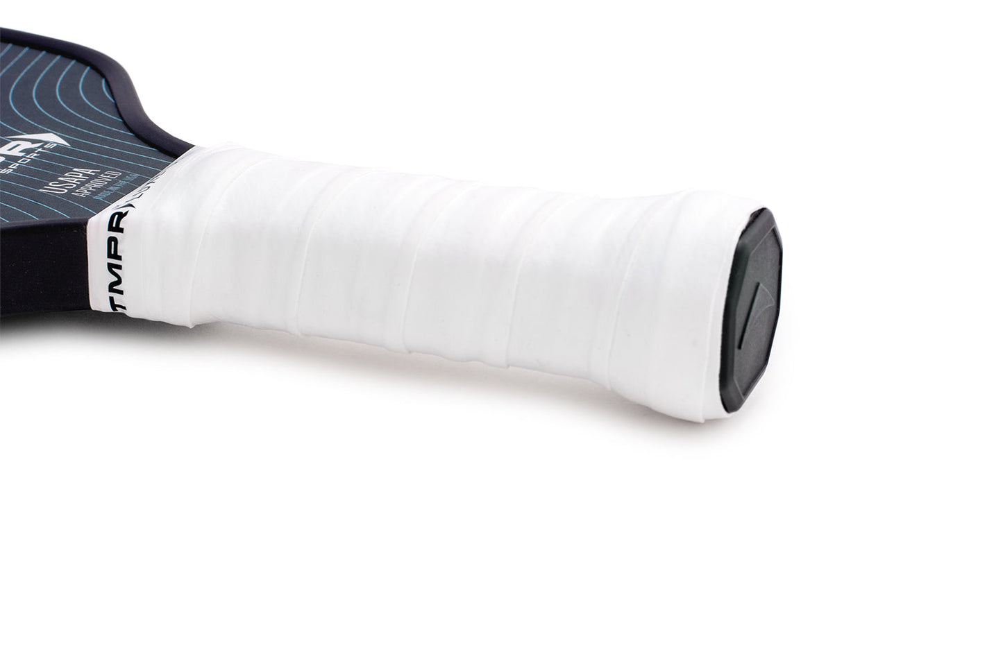 Close-up of a TMPR Luxe Comfort Overgrip from TMPR Sports, wrapped on a paddle handle for comfort and absorbency. The black end cap displays a triangular design, while the dark blue paddle face with white curves sits on the left.