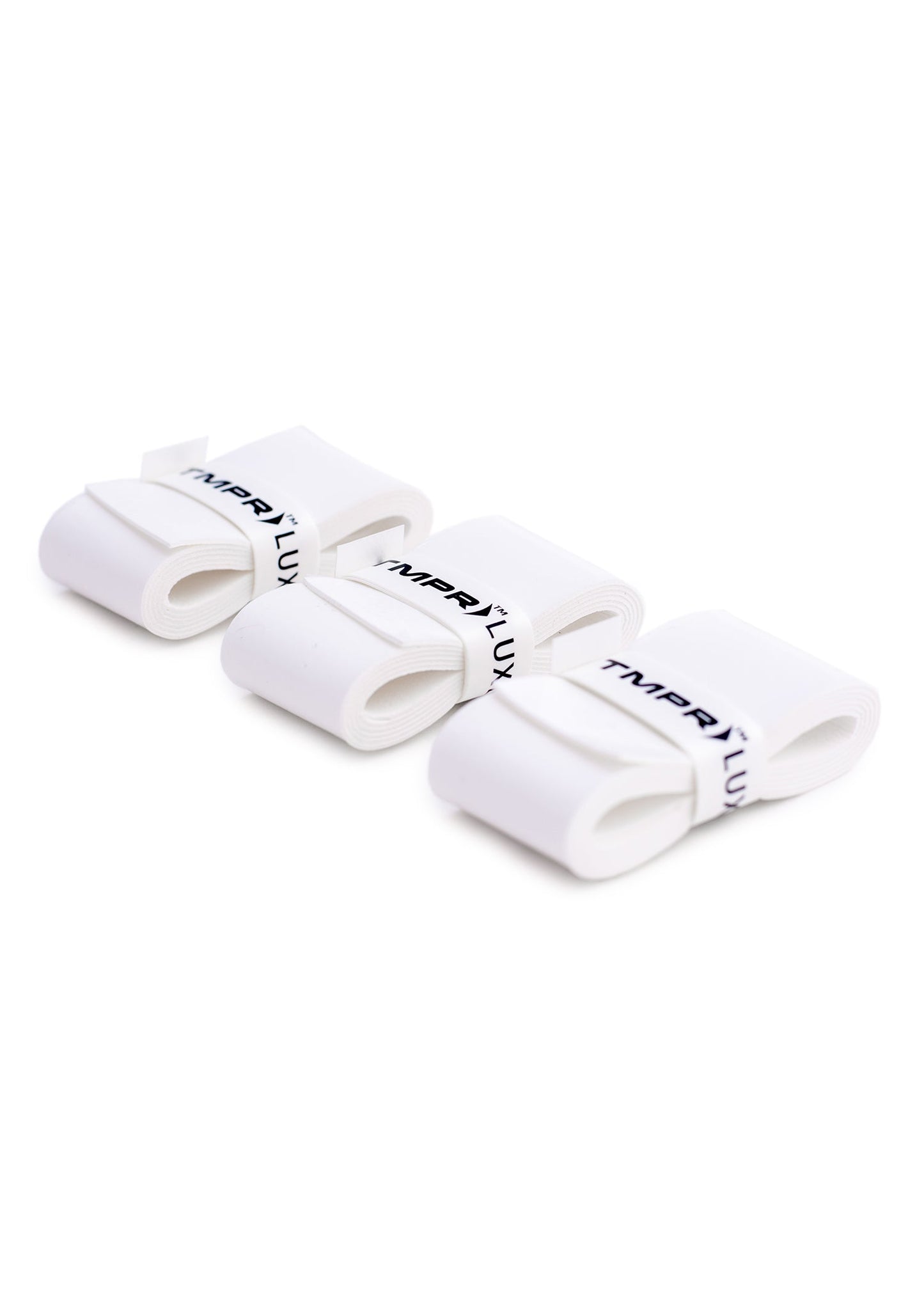Three TMPR Sports TMPR Luxe Comfort Overgrips, white with black TMPRTLUX text, are coiled and stacked diagonally. They feature smooth, flexible material for comfort and reliable absorbency.