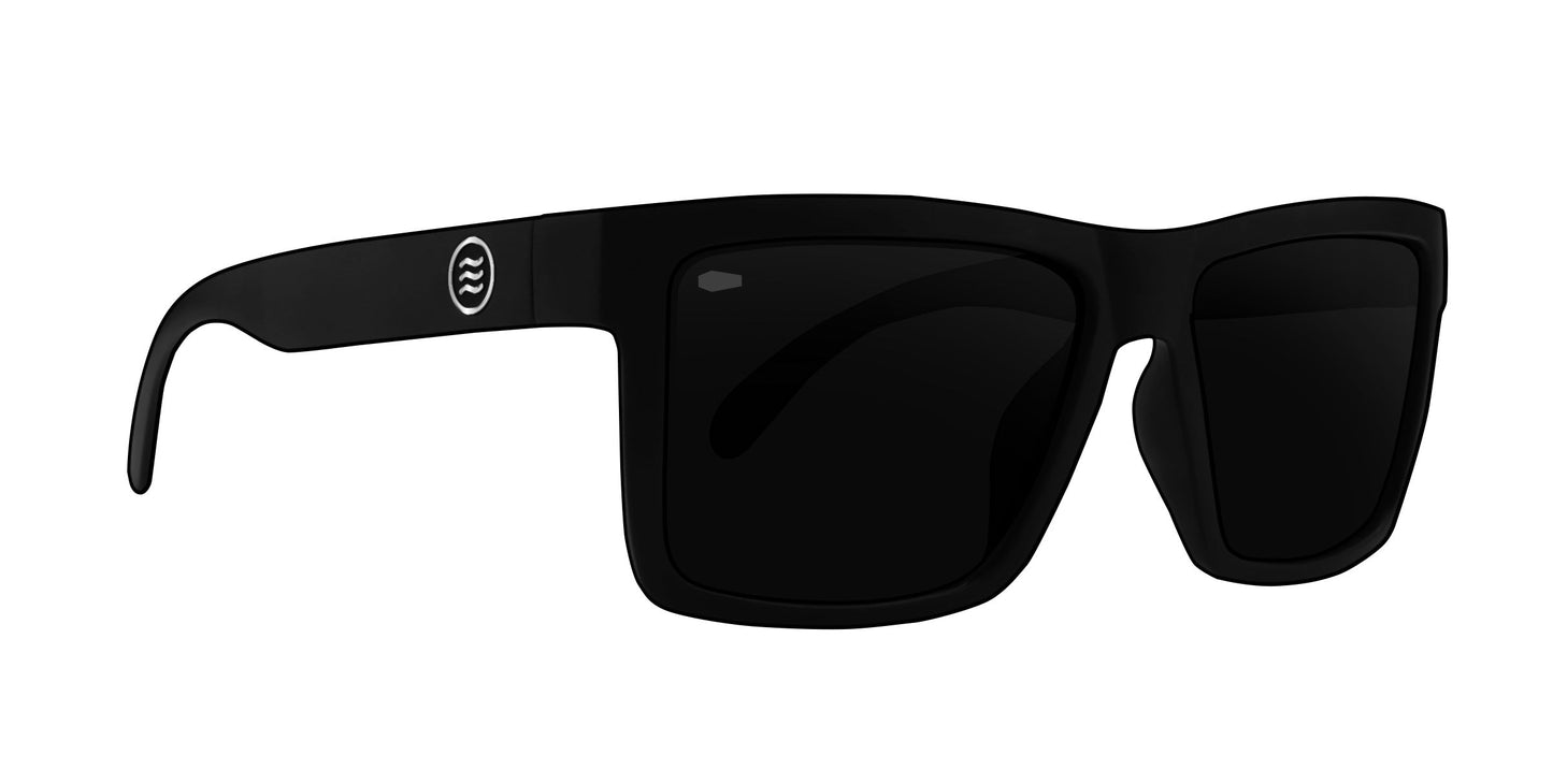 The Neven Eyewear Lowrider XL sunglasses feature oversized rectangular black frames, dark polarized lenses, and a small white circular wavy line logo on the left temple for a modern, sporty look.