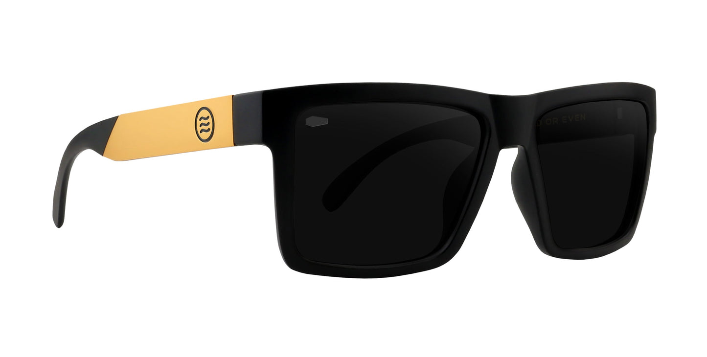 The Neven Eyewear Prospector XL sunglasses feature black rectangular frames with thick temples accented by yellow near the hinges and a circular logo. Polarized black lenses complete this bold, modern Tombstone XL Collection style.