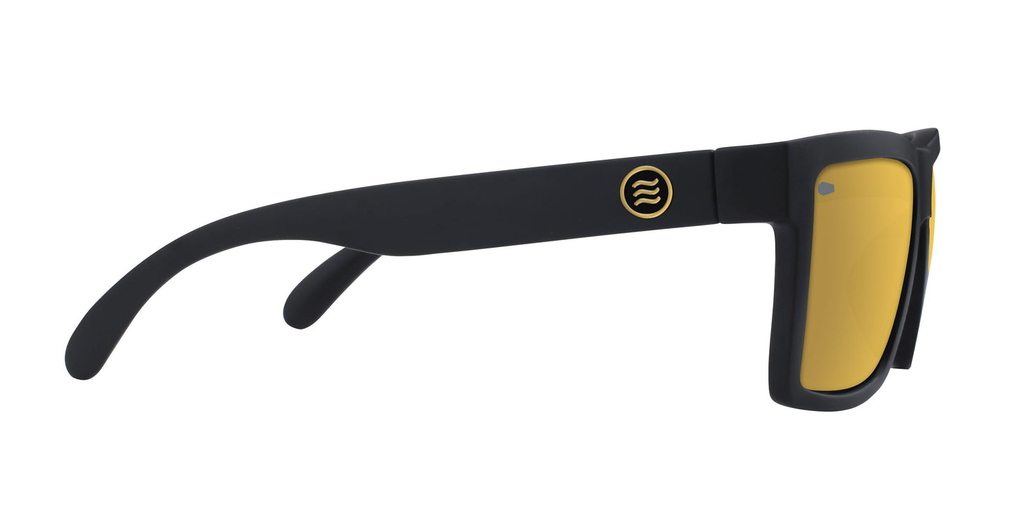 The Neven Eyewear Sentry XL sunglasses feature a large matte black frame, yellow-tinted polarized gold lenses, and a small gold circular wavy-line logo on the chunky rectangular temple arm.