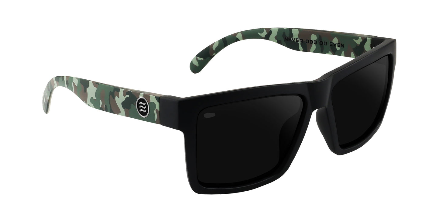The Bad Company sunglasses by Neven Eyewear feature thick black rectangular frames, dark polarized UV400 lenses, green and brown camo arms with a circular white logo, and "NEVER GOOD OR EVEN" printed inside.