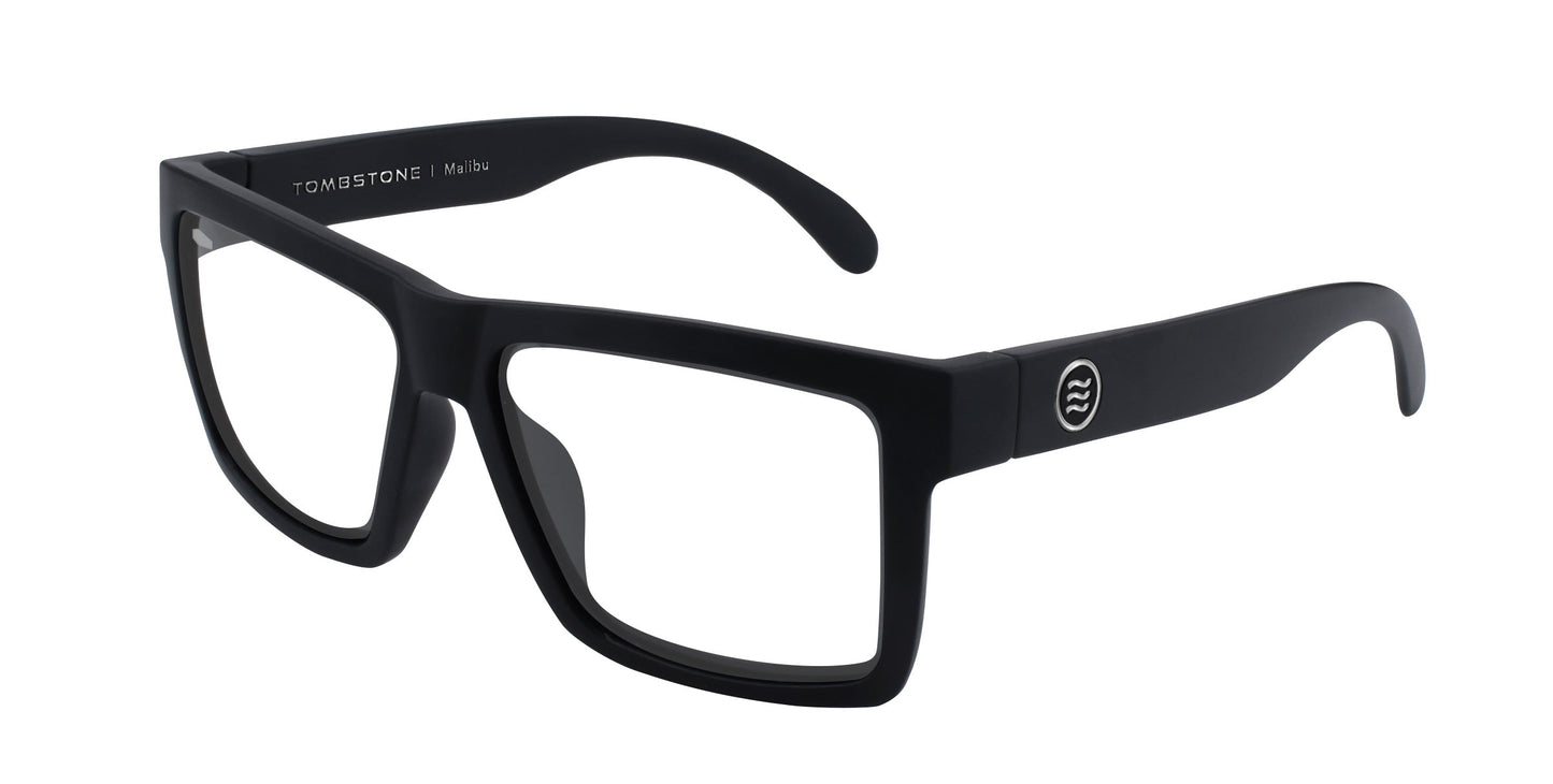 Black rectangular Malibu eyeglass frames by Neven Eyewear with clear lenses. Wide straight arms feature a small circular silver logo by the hinge. Bold design inspired by classic Malibu riding glasses for men.