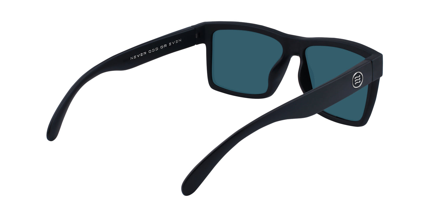 A pair of black rectangular Supernova sunglasses by Neven Eyewear from the Tombstone Collection face away, revealing “NEVER ODD OR EVEN” on the inside left arm. A round logo appears on the outside right arm. The lenses are dark tinted.