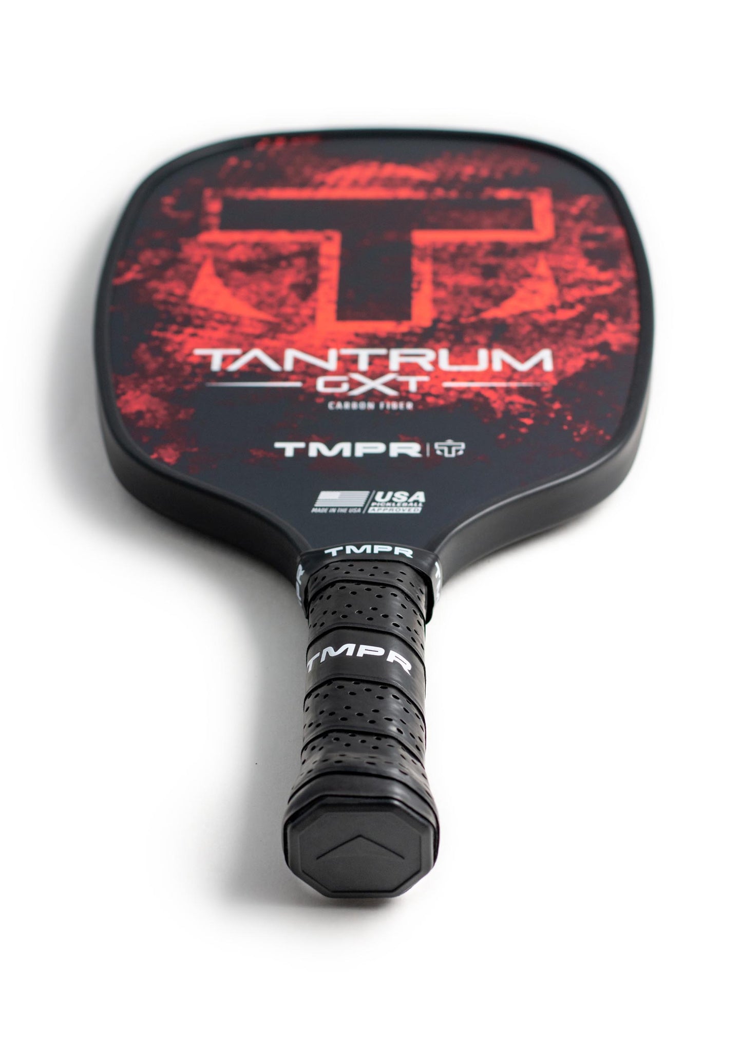 A black carbon fiber TMPR Sports Tantrum GXT pickleball paddle with a textured grip, red and black face, bold red “T” logo, and TANTRUM GXT plus TMPR branding with USA Pickleball approval logos on a white background.