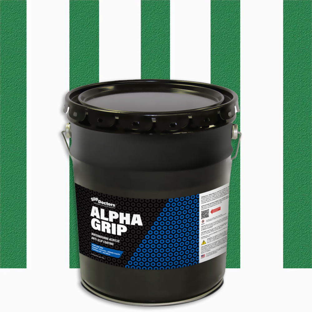 A large black bucket labeled “Alpha Grip Non-Slip Stripe and Athletic Court Paint” by SlipDoctors sits on a white surface with a green background featuring three wide vertical white stripes, a sturdy metal handle, and a blue-accented safety label.