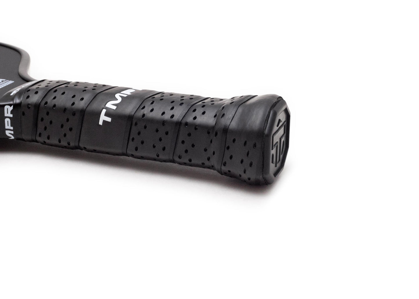 Close-up of the Terra TC-16 by TMPR Sports, showing its black perforated grip with vibration dampening and textured wrap. White TMPR branding is visible, along with an embossed end cap logo—all against a white background.