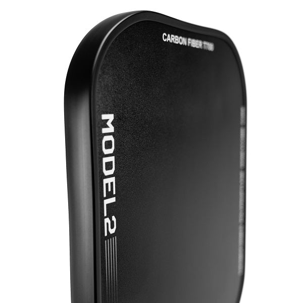 A close-up of The Big Dink - Model2 Pickleball Paddle showcases its black, matte carbon fiber finish, rounded edges, and sleek texture—ideal for players who value control and spin. Brand name "The Big Dink" is visible on the paddle.