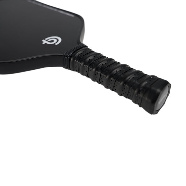 Close-up of The Big Dink - Model2 Pickleball Paddle handle with textured, perforated black grip tape for control. Minimalist The Big Dink logo hints at pro-level spin. Carbon fiber surface contrasts against a crisp white background.