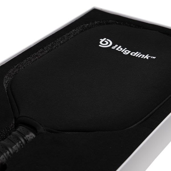 The Big Dink - Model2 Pickleball Paddle, a black carbon fiber paddle with a perforated grip and white logo, comes in a custom-fit black foam case inside a sleek white box. Brand: The Big Dink.