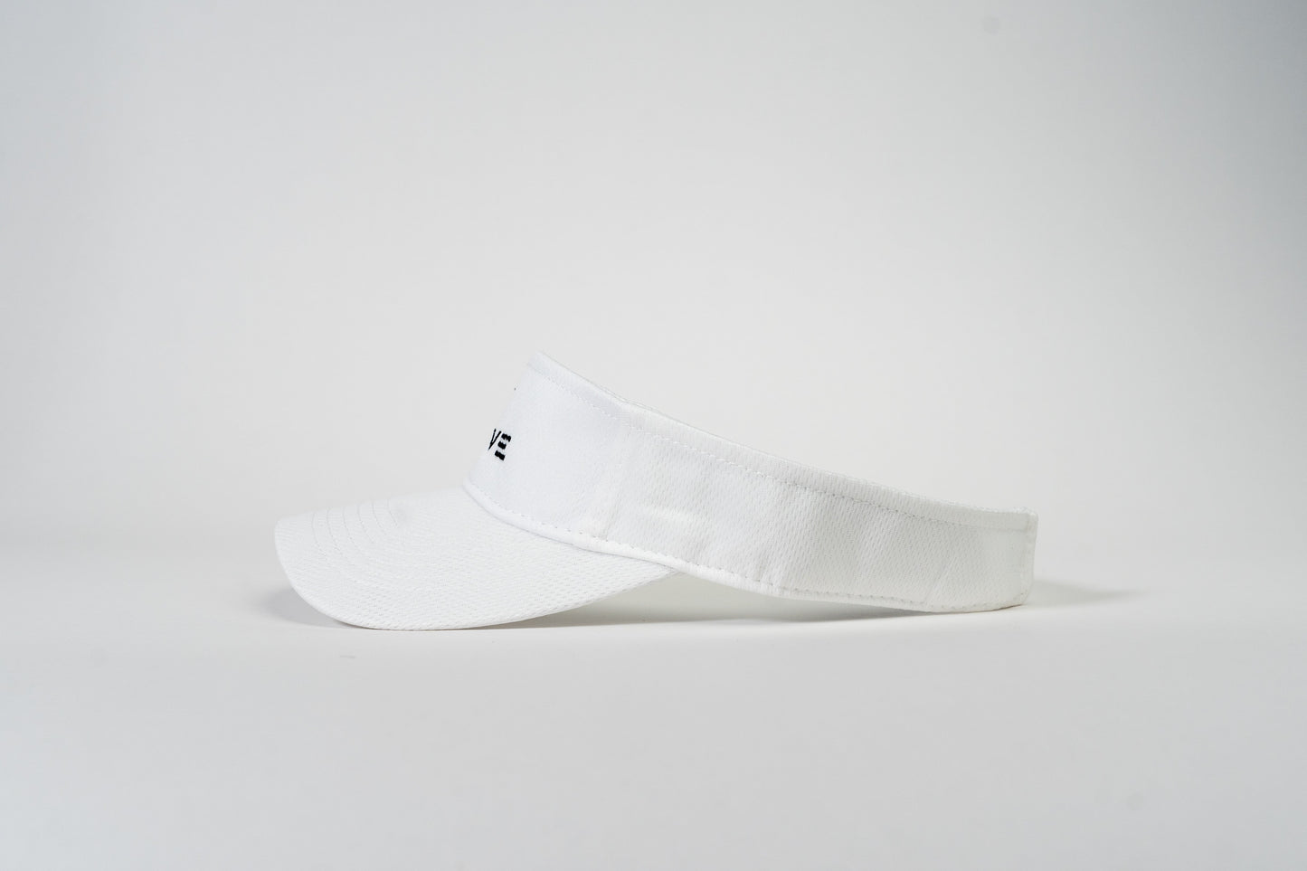 The Thrive Elite Tour Visor by Thrive Pickleball is displayed in a side profile view against a white background, featuring a curved brim, adjustable back strap, and partially visible black text on the front.