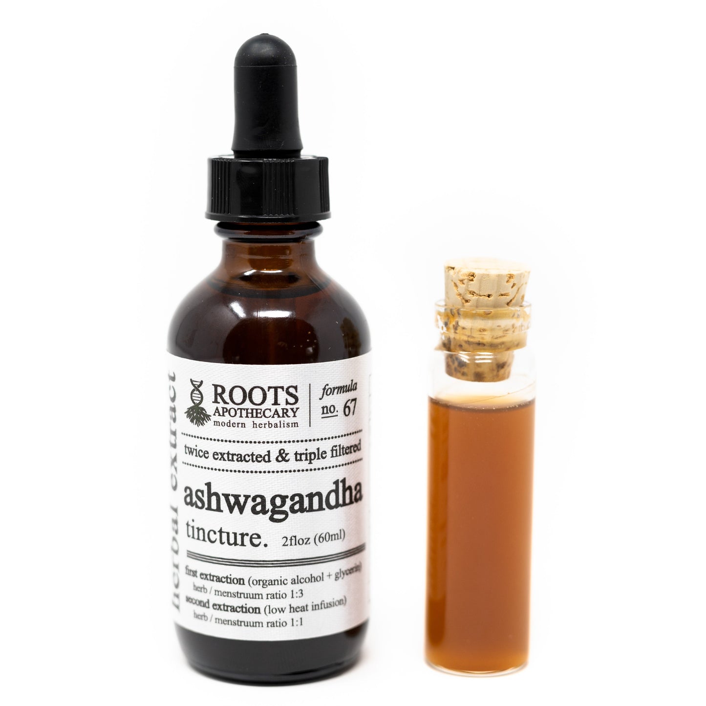 A brown glass dropper bottle labeled "Roots Apothecary ashwagandha tincture - organic" stands beside a small clear corked vial, both filled with amber adaptogen liquid. The label shares extraction info and highlights natural stress support.