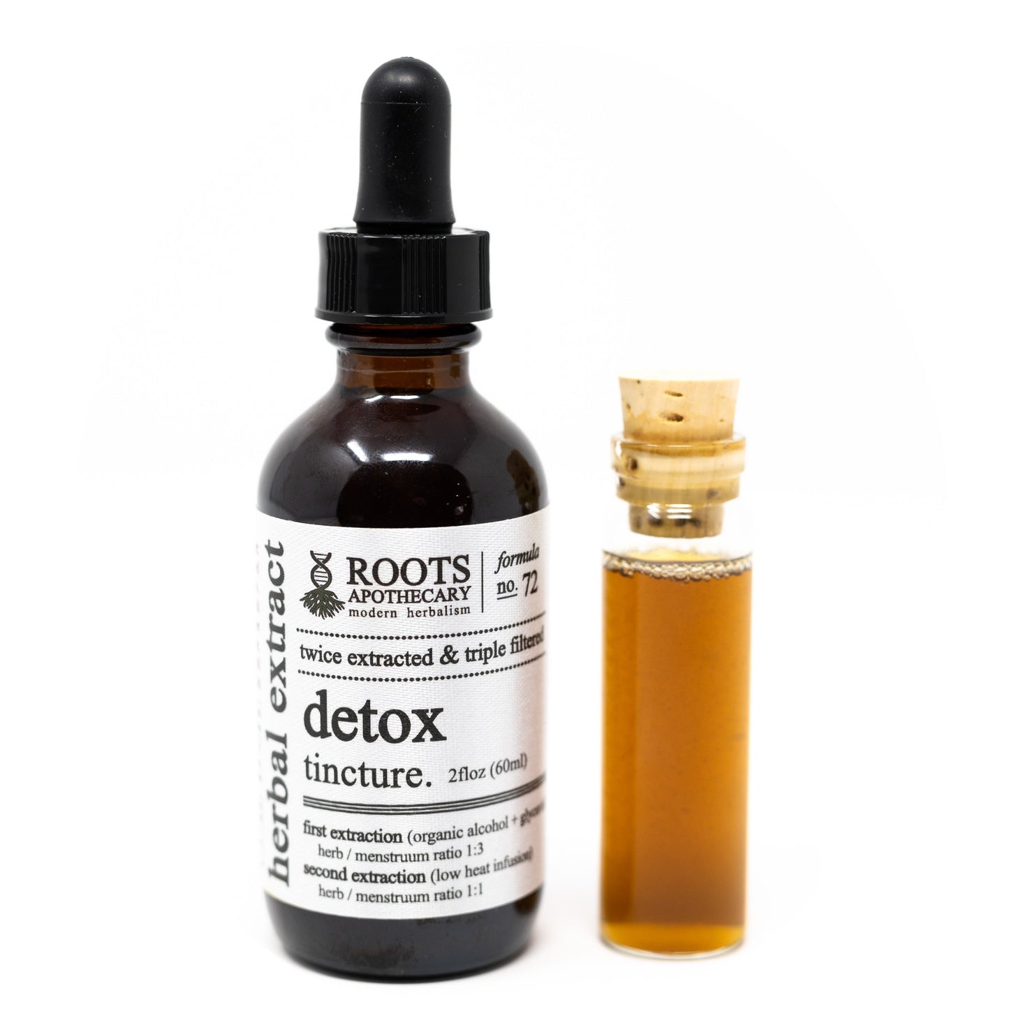 A dark glass dropper bottle labeled Roots Apothecary Detox Tincture sits beside a small corked vial of amber liquid on a white background, showcasing this herbal detox solution from Roots Apothecary.