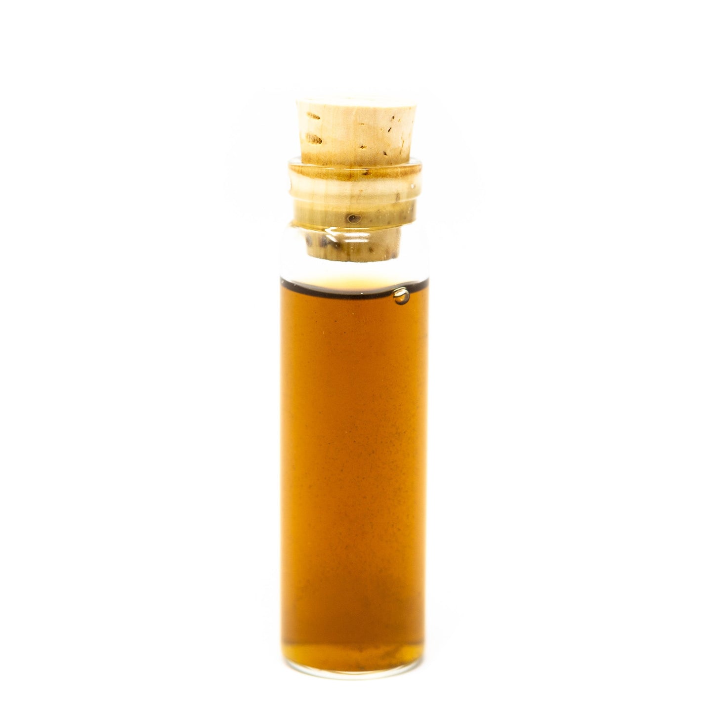 A small, clear glass vial of Roots Apothecary detox tincture with a light wooden cork stands upright on a white background. The amber liquid inside appears translucent and slightly viscous.