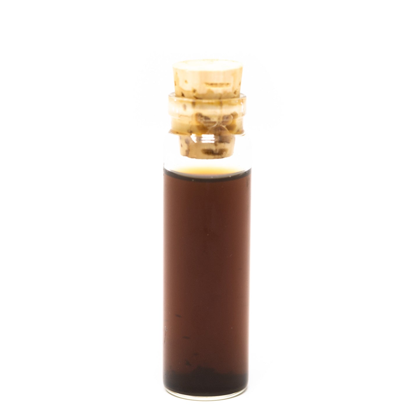 A small clear glass vial of Roots Apothecary holy basil tincture, filled with dark brown extract and sealed with a light tan cork, stands upright against a plain white background.