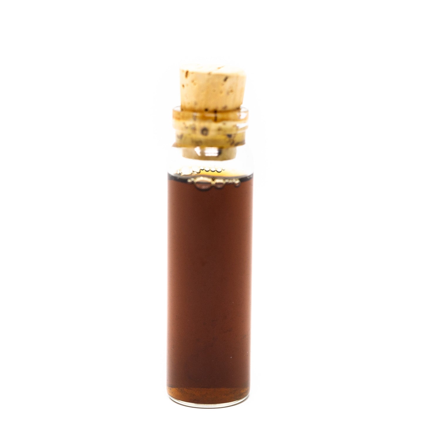 A small clear glass vial of immune boost tincture by Roots Apothecary, filled with dark brown liquid and sealed with a natural cork stopper, stands upright against a plain white background.