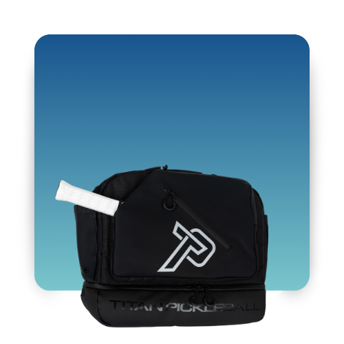 The Titan Pickleball Titan Duffle Bag, featuring a white TP logo and text on black, sits against a blue gradient backdrop. A white-handled paddle for tournament-ready players peeks from its side pocket.