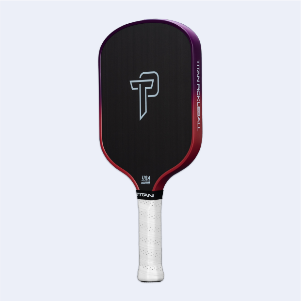 The Titan Pickleball Titan Ignite 16S paddle features a carbon fiber face, purple and red gradient border, white perforated grip, bold TP logo, and "TITAN PICKLEBALL" with USA approved text above the handle for top performance.