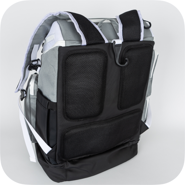 The Titan Pickleball Backpack by Titan Pickleball stands upright with a grey and black design, thick padded shoulder straps, large mesh back pads, side pockets, a bottom zip section, and white accent straps—all against a plain light background.
