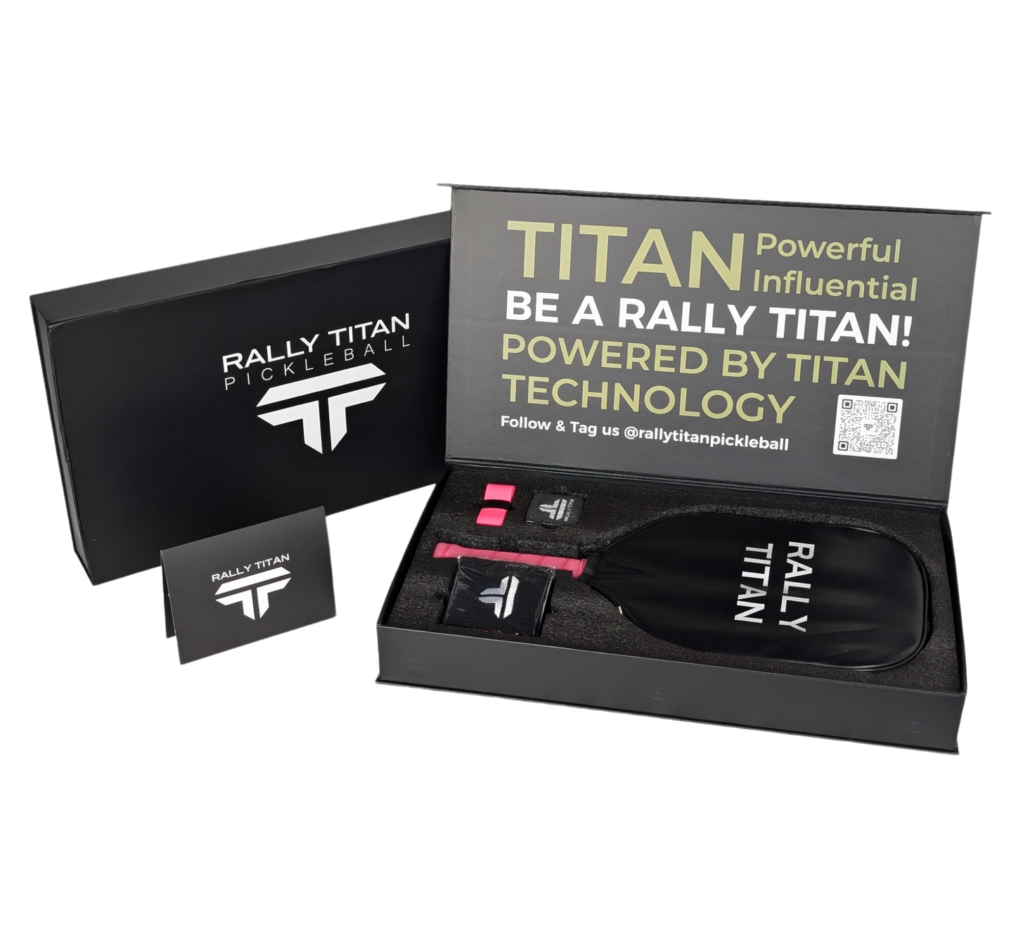 An open black box displays Rally Titan Pickleball gear, featuring the Titan Power 14MM paddle with thermoformed unibody construction, T700 Titan Carbon Friction Surface, pink grip tape, a small tool, and a lid reading: Be a Rally Titan!.