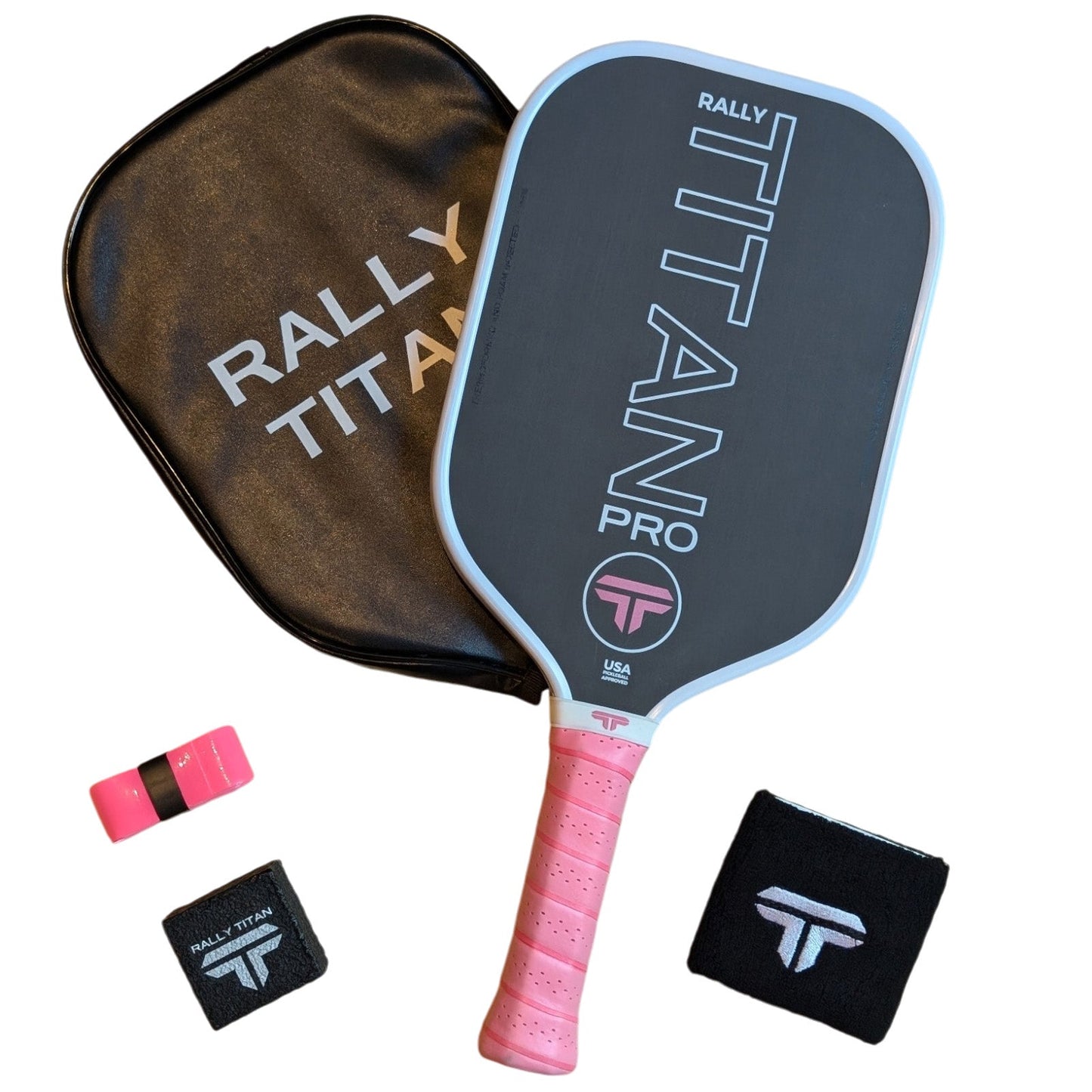 The Rally Titan Pickleball Titan Pro 16MM paddle, featuring a T700 Titan Carbon Friction Surface and white with pink accents, is displayed with its case, pink overgrip, and two black wristbands with white logos.