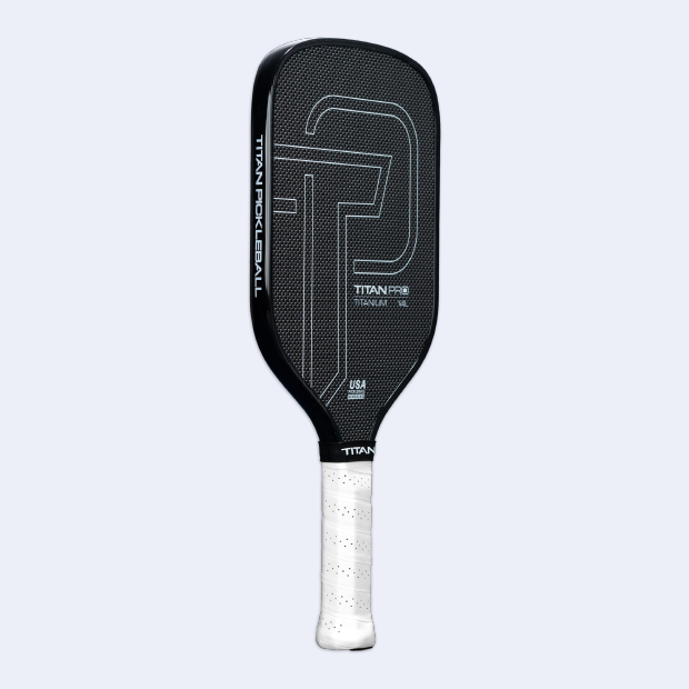 The Titan Pickleball Titan Pro Titanium 14L is a black carbon fiber professional paddle with a white grip, large gray T design, “TITAN PRO” and “TITAN PICKLEBALL” labeling, USA-made text, on a light gray background.